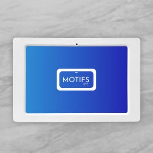 May include: A white tablet with a blue gradient screen. The screen displays the text "MOTIFS ETC" inside a white rectangle. The tablet is set against a gray marble background.