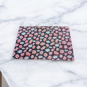 May include: Rectangular decorative tray with a repeating pattern of pink pigs, blue clouds, and stars on a navy blue background. The tray is likely made of a durable material and is suitable for serving or display.