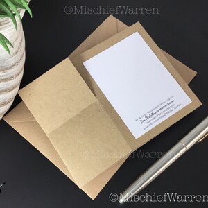 Pu&ograve; includere: Un biglietto di auguri con interno bianco &egrave; inserito in una busta di carta kraft. Una penna d'argento &egrave; appoggiata su una superficie nera accanto al biglietto. Il biglietto e la busta fanno parte di un set di cancelleria. Il testo "Mischief Warren" &egrave; visibile.