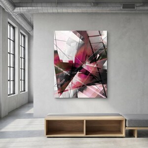 May include: Abstract geometric art print with a modern design. The artwork features a complex arrangement of shapes in shades of pink, black, and white, creating a dynamic and visually engaging composition. The print is displayed in a minimalist interior setting.