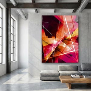 May include: Abstract art piece with a vibrant mix of colors, including red, orange, and yellow, with white lines. The artwork is displayed on a gray wall in a modern living room setting. A gray sofa and wooden coffee table are in front of the artwork.