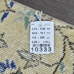 May include: A beige rug with a floral pattern in shades of blue, green, and brown. The rug is 3.74 feet by 6.56 feet, 44.8 inches by 78.7 inches, or 114 cm by 200 cm. The rug weighs 4.34 kg.