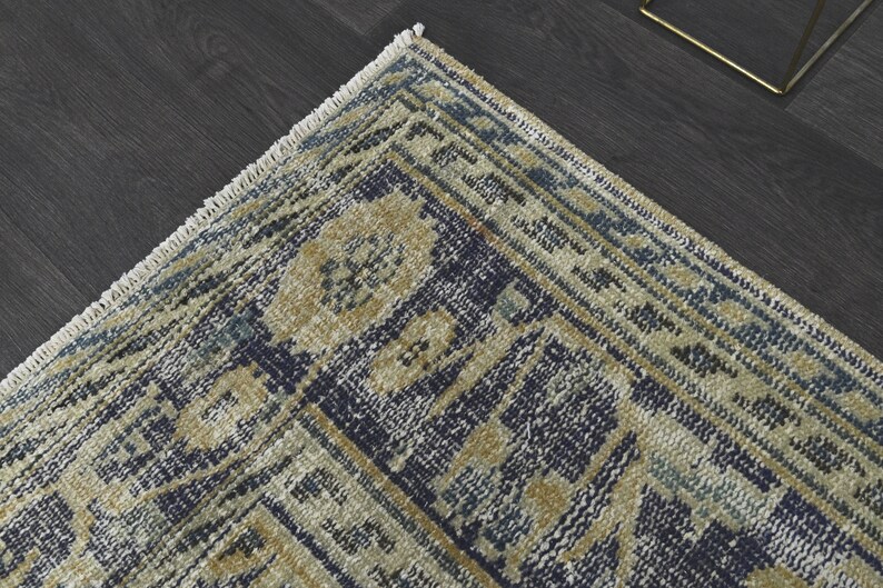 May include: A blue and beige patterned rug with a fringe border. The rug has a traditional design with intricate details.
