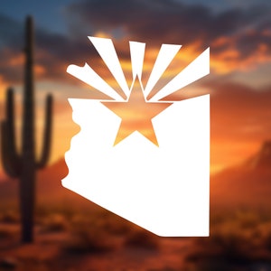 May include: White silhouette of the state of Arizona with a star and sunburst design, set against a desert sunset backdrop. The image features a cactus and mountains, evoking the state's landscape.