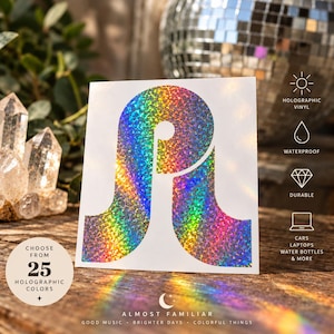 May include: A square white sticker featuring a large, stylized letter P in a rainbow-colored holographic finish. The design includes text icons for holographic vinyl, waterproof, durable, and usage for cars, laptops, and water bottles, plus a 25-color choice label.