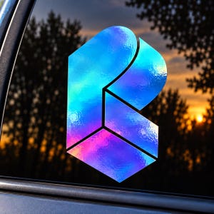 May include: A holographic decal featuring a stylized letter R design. The sticker has a reflective, iridescent surface that shifts between shades of blue, purple, and pink, creating a metallic, multi-dimensional appearance on the glass surface.