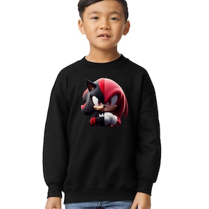 May include: A black sweatshirt with a graphic print of Shadow the Hedgehog from the Sonic the Hedgehog video game series. The graphic shows Shadow with his red and black color scheme.