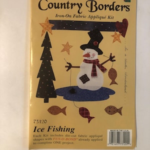 May include: A craft kit for making a winter wonderland scene. The kit includes die-cut fabric appliques with FUS-O-BOND already applied. The kit is called "Holiday Country Borders" and the design is "Ice Fishing".