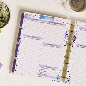 May include: A purple and blue planner with a watercolour design of crystals and stars. The planner has sections for income, fixed expenses, variable expenses, and other expenses. It also has a section for totals.