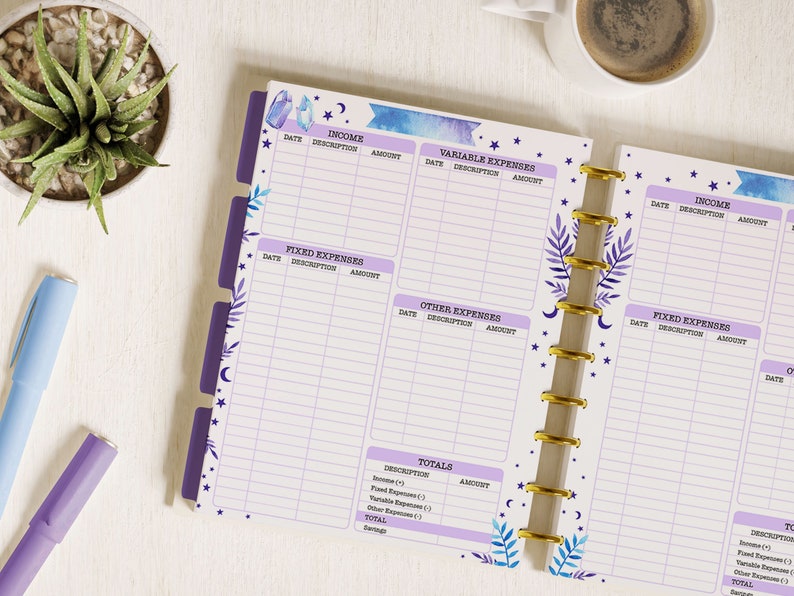 May include: A purple and blue planner with a watercolour design of crystals and stars. The planner has sections for income, fixed expenses, variable expenses, and other expenses. It also has a section for totals.