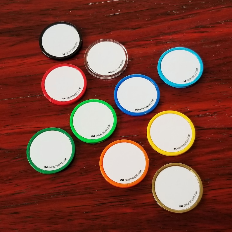 May include: A selection of circular tokens with white centres and rims in various colours, including black, red, green, blue, yellow, orange, and gold. Each token has the text "infinitetokens.com" printed on it.