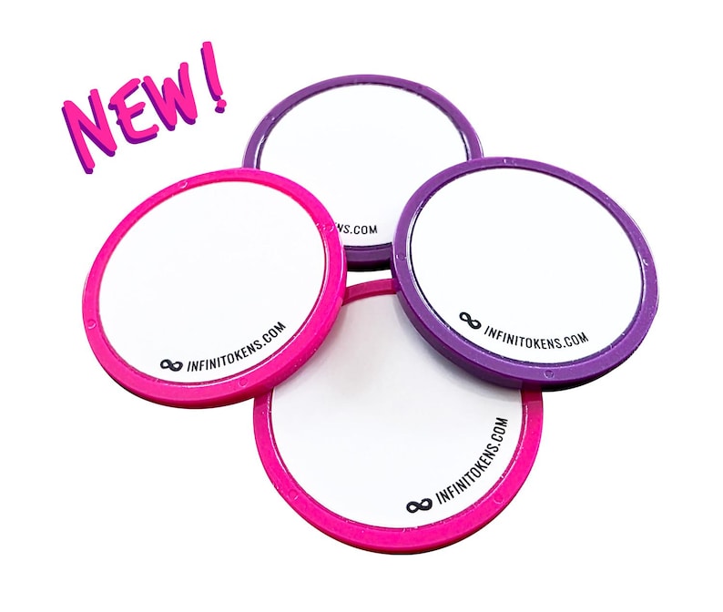 May include: Four circular tokens with white centres and pink and purple rims. The text "NEW!" is in pink, and the website "INFINITOKENS.COM" is printed on the tokens.