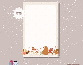 May include: A notepad with a whimsical autumn-themed border featuring a bear, squirrel, mushrooms, and leaves. The notepad is 5.5" x 8.5" and has 50 sheets. The words "MAILED TO YOU" are on a starburst. The background is a light beige color.