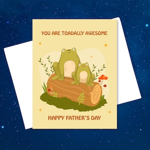May include: A yellow card with a green frog and a smaller green frog sitting on a brown log. The card says "You are toadally awesome" and "Happy Father's Day".