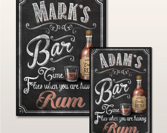 May include: Two chalkboard signs with a bar theme. The signs are black with white lettering and feature the text "Mark's Bar Time Flies When You Are Having Rum" and "Adam's Bar Time Flies When You Are Having Rum". Each sign has a bottle of rum and a glass of rum on it.