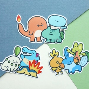 May include: A set of nine cartoon character stickers featuring various Pokemon characters, including Bulbasaur, Charmander, Squirtle, and others. The stickers are printed on white paper and have a glossy finish.