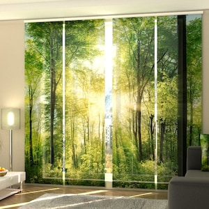 May include: Panel curtains featuring a vibrant forest scene with tall green trees and bright sunlight filtering through the canopy. The curtains create a natural, serene ambiance, perfect for living rooms or bedrooms. The design includes a sofa and decorative pillows.