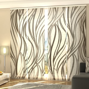 May include: A white room with a brown patterned window blind. The blind is made of fabric and has a wavy design with brown lines and small white dots. The blind is pulled down to cover the window.