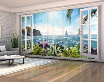 May include: A room with a large window displaying a tropical ocean view. The white-framed window is open, showing a sailboat on blue water, a sunny sky, and vibrant greenery. The room features a grey sofa and a round coffee table.