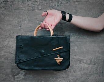 Asymmetric Black Leather Handbag: Mirrored Design with Bamboo Handles, Minimalist Fashion