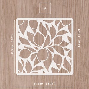 May include: A white, square stencil with a lemon and leaf design. The stencil measures 5.71 inches wide, 5.3 inches tall, and 1.4 inches thick. The letter "A" is in the upper left corner.