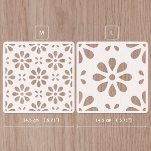 Peut inclure: Deux panneaux décoratifs en blanc découpés au laser avec un motif floral. Le panneau de gauche est étiqueté "M" et mesure 14,5 cm. Le panneau de droite est étiqueté "L" et mesure 14,5 cm.