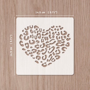 May include: White plastic stencil featuring a leopard print heart design. The stencil measures 5.71 inches by 5.71 inches.