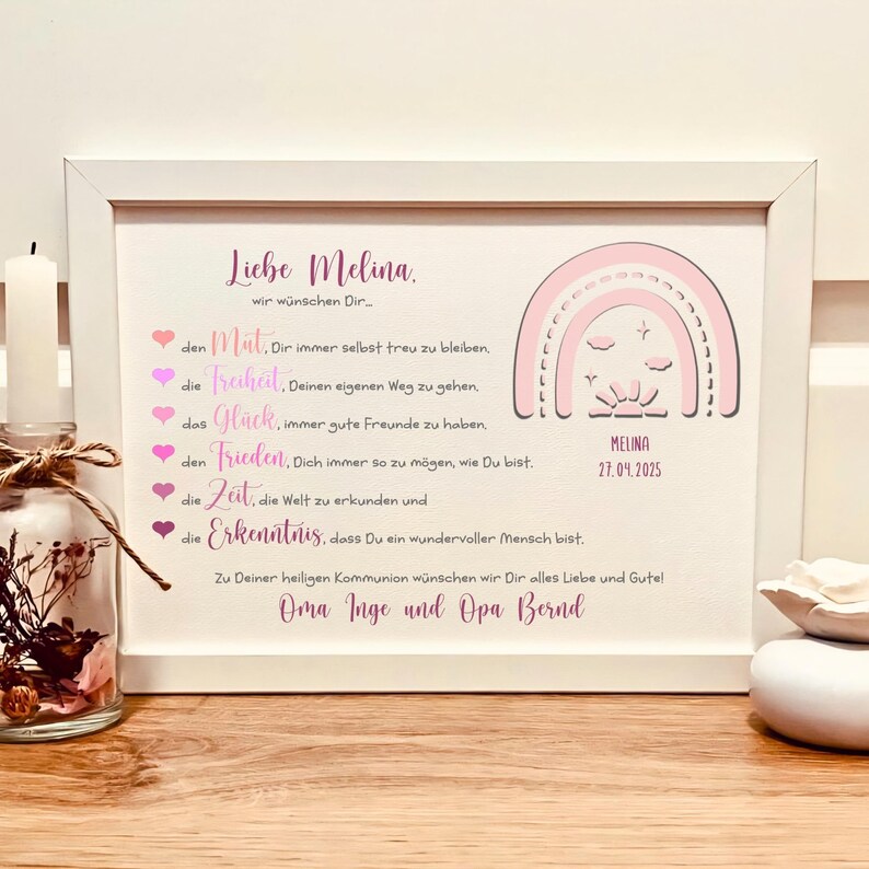 May include: A white framed print featuring a pink rainbow graphic, the name Melina, and the date 27.04.2025. The text includes German wishes for courage, freedom, happiness, peace, time, and knowledge, signed by Oma Inge and Opa Bernd.