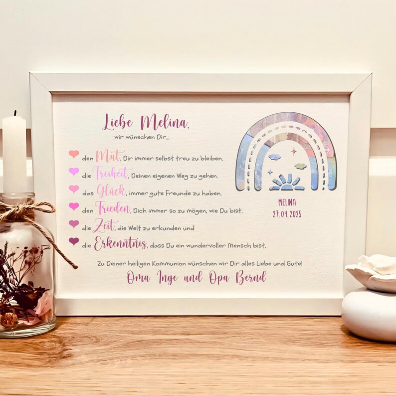 May include: A white framed print featuring a rainbow graphic, the name Melina, the date 27.04.2025, and German text listing wishes for courage, freedom, happiness, peace, time, and knowledge, signed by Oma Inge and Opa Bernd.