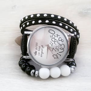 May include: A black and white wristwatch with a black leather band and white beads. The watch face has the text "Who cares I'm late anyways" and numbers around the edge.