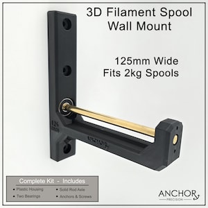 May include: Black 3D filament spool wall mount, 12.5cm wide, designed to fit 2kg spools. Includes plastic housing, solid rod axle, two bearings, and anchors and screws. The text on the mount reads "ANCHOR".