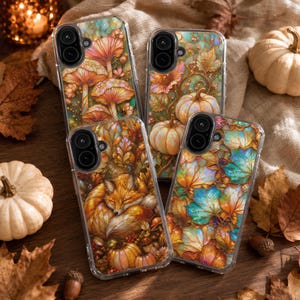 May include: Four clear smartphone cases featuring autumn-themed designs. One case displays orange mushrooms, another shows pumpkins, a third features a sleeping fox among pumpkins, and the fourth depicts a pattern of colorful fall leaves.