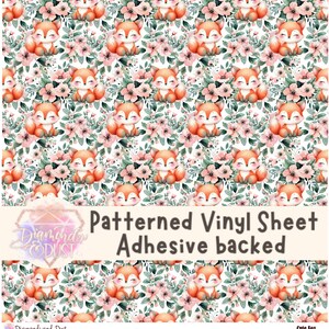 May include: Patterned vinyl sheet with a repeating pattern of cartoon foxes and floral elements in shades of orange, pink, and green. The text "Patterned Vinyl Sheet Adhesive backed" is displayed.