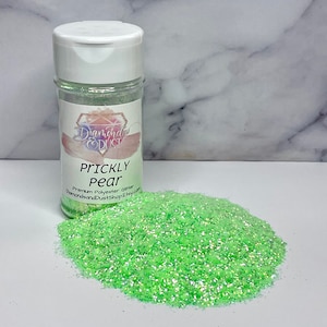 May include: A jar of green glitter with a white label that says "Prickly Pear Premium Polyester Glitter DiamondsandDustShop.Etsy.com"