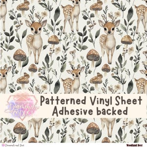 May include: Patterned vinyl sheet with a woodland deer design. The pattern features deer, mushrooms, and foliage in shades of brown, beige, and green on a cream background. The text "Patterned Vinyl Sheet Adhesive backed" is visible.
