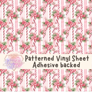 May include: A patterned vinyl sheet with a repeating design of candy canes and pink flowers. The background features vertical stripes in pink and white. The text "Patterned Vinyl Sheet Adhesive backed" is displayed.
