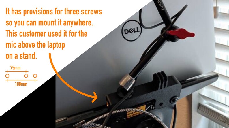 May include: A black metal laptop stand with a red lever and a cable lock. The stand has three screw holes for mounting. The stand is attached to a laptop with the Dell logo visible. The stand has a 75mm and 100mm measurement.