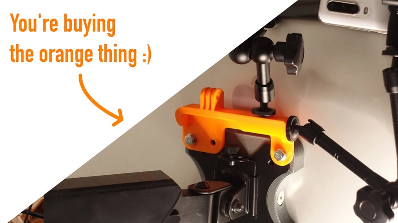 May include: Orange 3D printed GoPro mount with a black adjustable arm and a black ball head. The mount is attached to a black tripod.