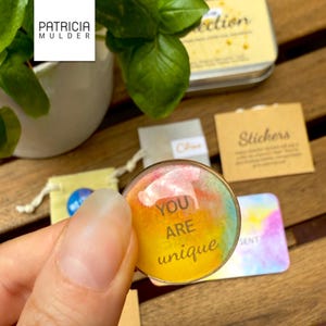 Little box of connection made to inspire and bring people together. Includes discovery papers that ask meaningful prompts and power glass pebbles with you are kind, you are strong and other versions. Also 9 affirmation cards, and a small glassine envelope with 6 little gemstones. There’s also a paper pouch with 3 eco friendly stickers in this box. You can pick a blue, yellow or green front and citrine, amethyst or rose quartz gems. Share with friends, lift spirits and gift the gift of connection