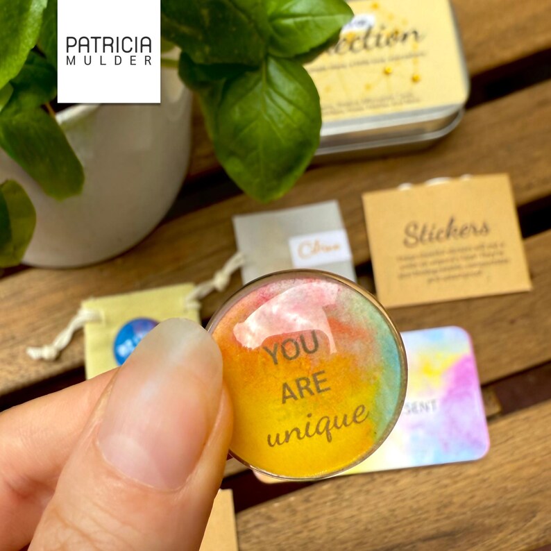 Little box of connection made to inspire and bring people together. Includes discovery papers that ask meaningful prompts and power glass pebbles with you are kind, you are strong and other versions. Also 9 affirmation cards, and a small glassine envelope with 6 little gemstones. There’s also a paper pouch with 3 eco friendly stickers in this box. You can pick a blue, yellow or green front and citrine, amethyst or rose quartz gems. Share with friends, lift spirits and gift the gift of connection