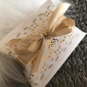 White & gold favour boxes with ribbon