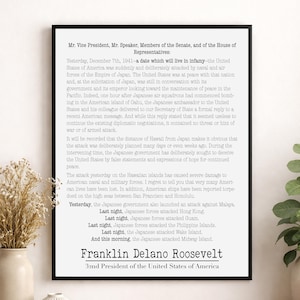 May include: A framed historical document featuring the text of Franklin Delano Roosevelt's Infamy Speech. The print displays black typewriter-style text on a white background, detailing the events of 7 December 1941, and the declaration of war.