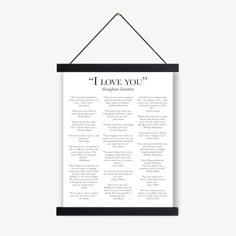 May include: A white vertical wall hanging poster featuring the title I LOVE YOU throughout literature in black text. The poster displays various literary quotes about love from authors like Jane Austen and William Shakespeare, held by black wooden rails.