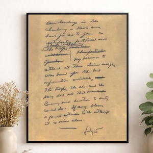 May include: A framed print of a handwritten letter on aged paper. The text is in dark blue ink, with the date "July 5" at the bottom. The frame is black, and the paper has a vintage, yellowish hue.