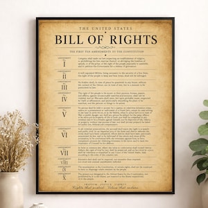 May include: A framed wall poster featuring the United States Bill of Rights with a vintage-style tan background and black text. The document lists the first ten amendments to the Constitution, starting with the title Bill of Rights in bold print.