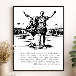 May include: A black and white framed wall art print featuring a Roman soldier standing on a battlefield with a sword raised. Below the illustration is the text: Cowards die many times before their deaths; The valiant never taste of death but once.