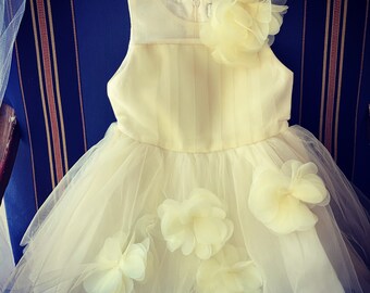Girls dress in Off white with a hint of pale yellow
