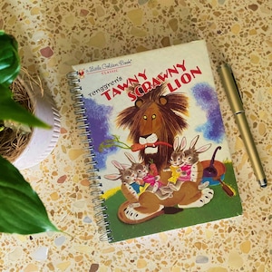 May include: A Little Golden Book classic, "Tawny Scrawny Lion" by Tenggren's, features a colourful illustration of a lion with three bunnies on a green background.