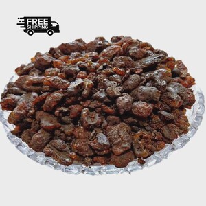 May include: A clear glass plate filled with dark brown, irregularly shaped pieces. The pieces have a glossy appearance and vary in size. The image includes a "FREE SHIPPING" graphic with a truck icon in the upper left corner.