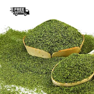 May include: Close-up of dried green herbs in wooden bowls and scattered on a white surface. The herbs are finely chopped and appear to be a culinary ingredient. The image includes the text "FREE SHIPPING".